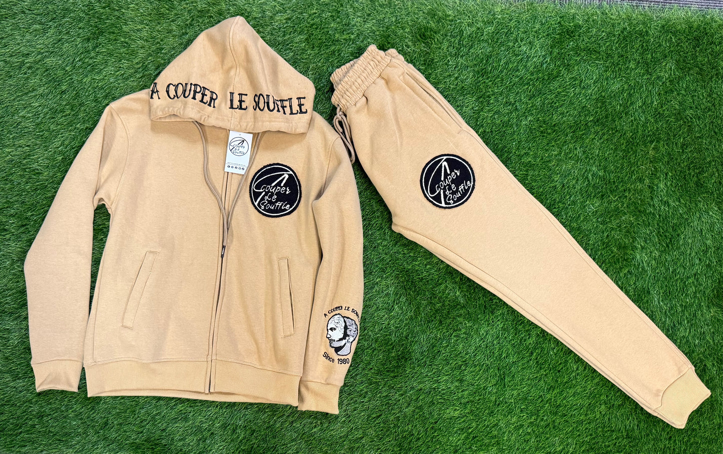 A Couper Le Souffle Unisex Tan SweatSuit Logo